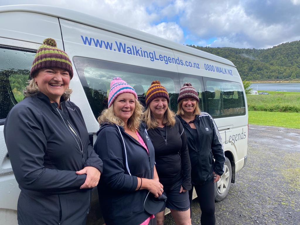 Four female hikers with Walking legends tour vehicle