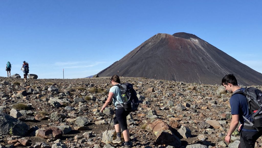 a hiker on the Tongariro Northern Circuit with Mt Ngauruhoe in the background
