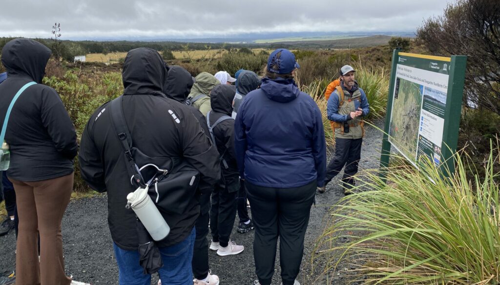 Walking Legends hiking guide delivers safety briefing to group in Tongariro National Park