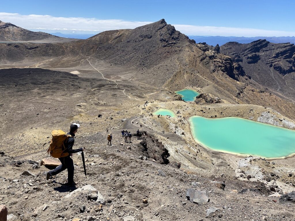 A hikers descends the scree slope on the Tongariro Alpine Crossing