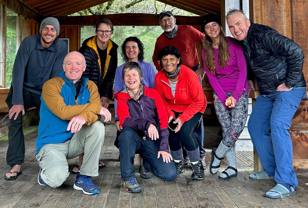 Group of smiling hikers in day shelter