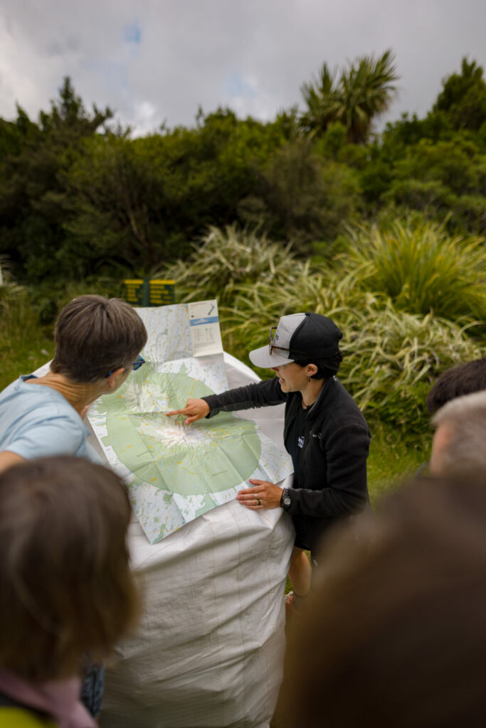 Walking Legends hiking guide checks map of Mount Taranaki walks