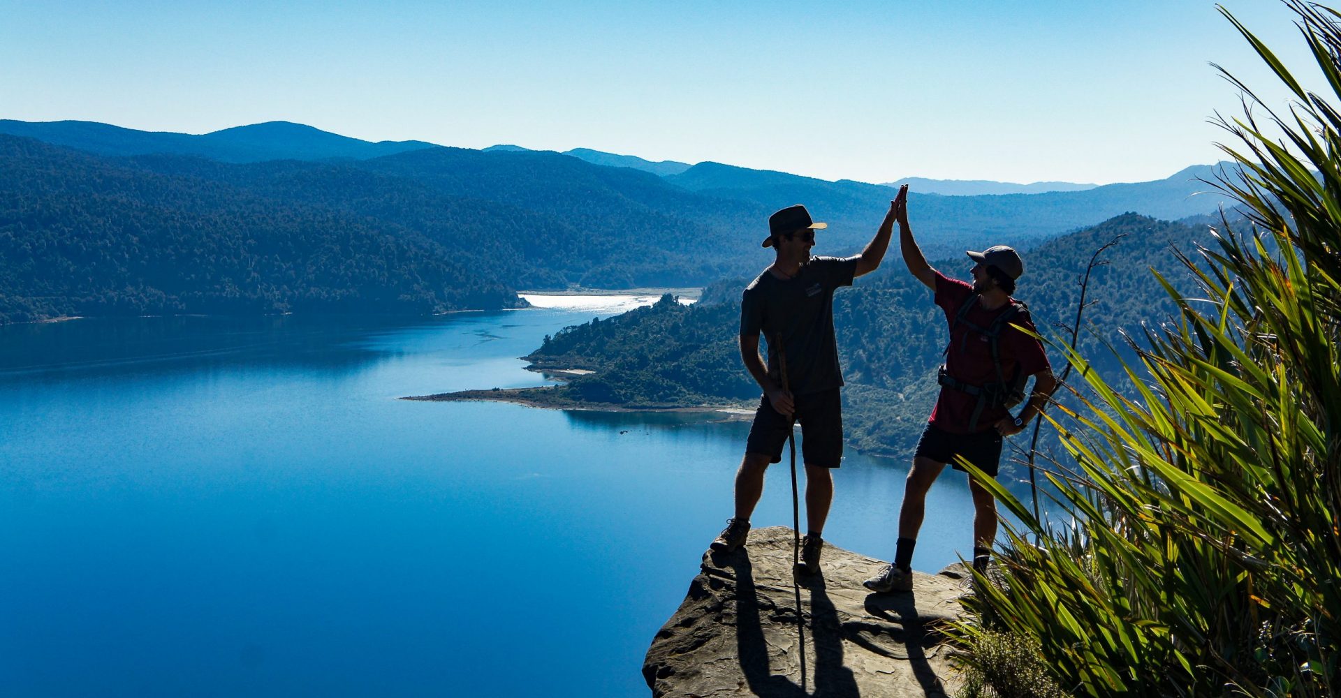 Two hikers on Panekire Bluff highfiving