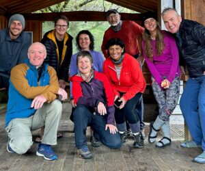 Group of smiling hikers in day shelter